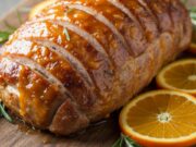 Arista all’arancia morbida come il burro: il trucco del taglio a fisarmonica Arista di maiale cotta a fisarmonica con glassa all'arancia, lucida e tenera, servita su tagliere rustico.