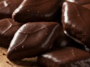 Impasto veloce per i mostaccioli: pronti in 30 minuti senza lievito Mostaccioli napoletani al cioccolato, biscotti speziati a forma di rombo su piatto di ceramica rustica.