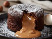 Cuore caldo di torrone e cioccolato: un’esplosione golosa per chi ama il confort Tortino al cioccolato fondente con cuore caldo di torrone morbido fuso, servito su piatto rustico.