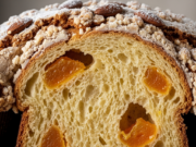 Colomba di Pasqua 2026 veloce: la ricetta economica senza impasto e senza stampo Macro di una fetta di colomba veloce cotta, che mostra l'alveolatura soffice, i canditi di arancia e la glassa croccante con mandorle.