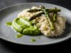 Risotto agli asparagi: la tecnica per mantenere il colore verde ed evitare sprechi Risotto agli asparagi cremoso color smeraldo con punte abbrustolite e vapore leggero su piatto di ceramica.