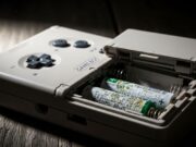 Il Game Boy in soffitta si sta rovinando: gli errori invisibili di conservazione Game Boy DMG-01 con vano batterie aperto che mostra pile AA corrose da idrossido di potassio