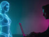 Milioni di follower per una donna che non esiste: la storia vera dietro il film di Brizzi Ologramma di una donna generata dall'intelligenza artificiale osservato da un uomo al computer, immagine simbolo del film Quasi Vera di Fausto Brizzi