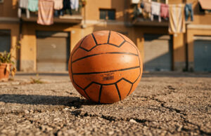 Il Super Santos e il mistero mai risolto su chi lo ha davvero inventato Pallone Super Santos arancione usato su asfalto di un cortile italiano, ricordo degli anni '90